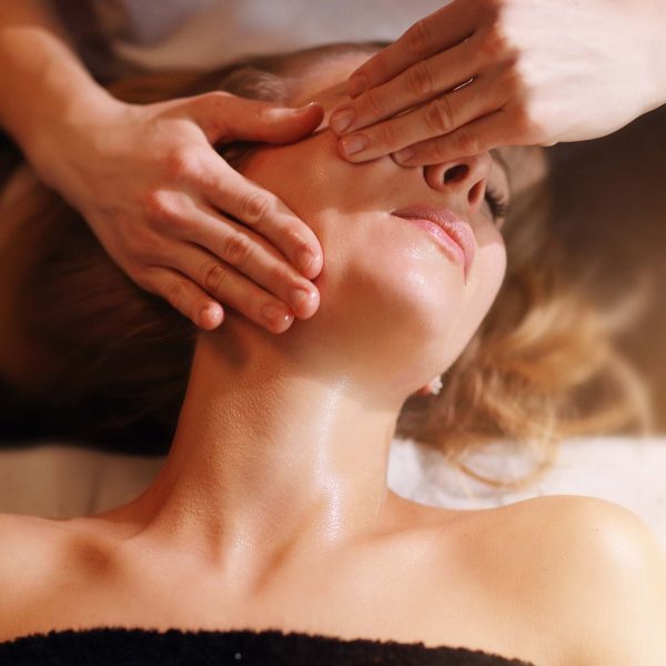 happy-woman-having-face-massage-in-spa-salon-BB2ASVD.jpg